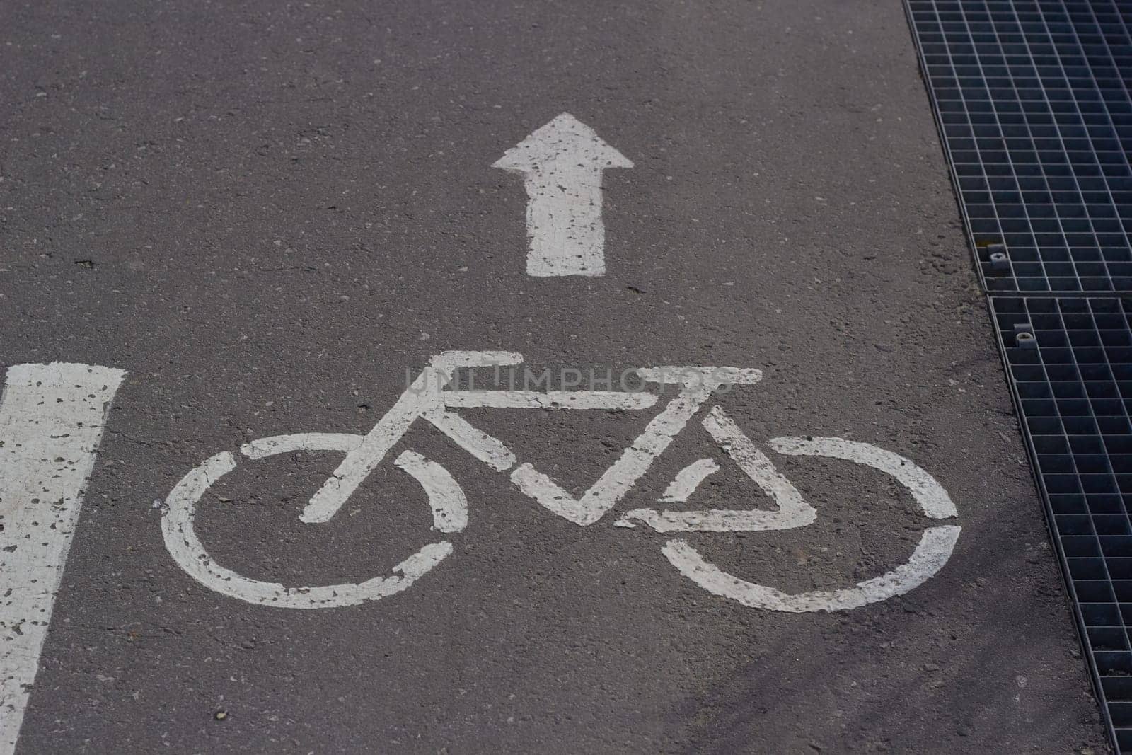 sign on pavement bicycle white paint arrow by electrovenik
