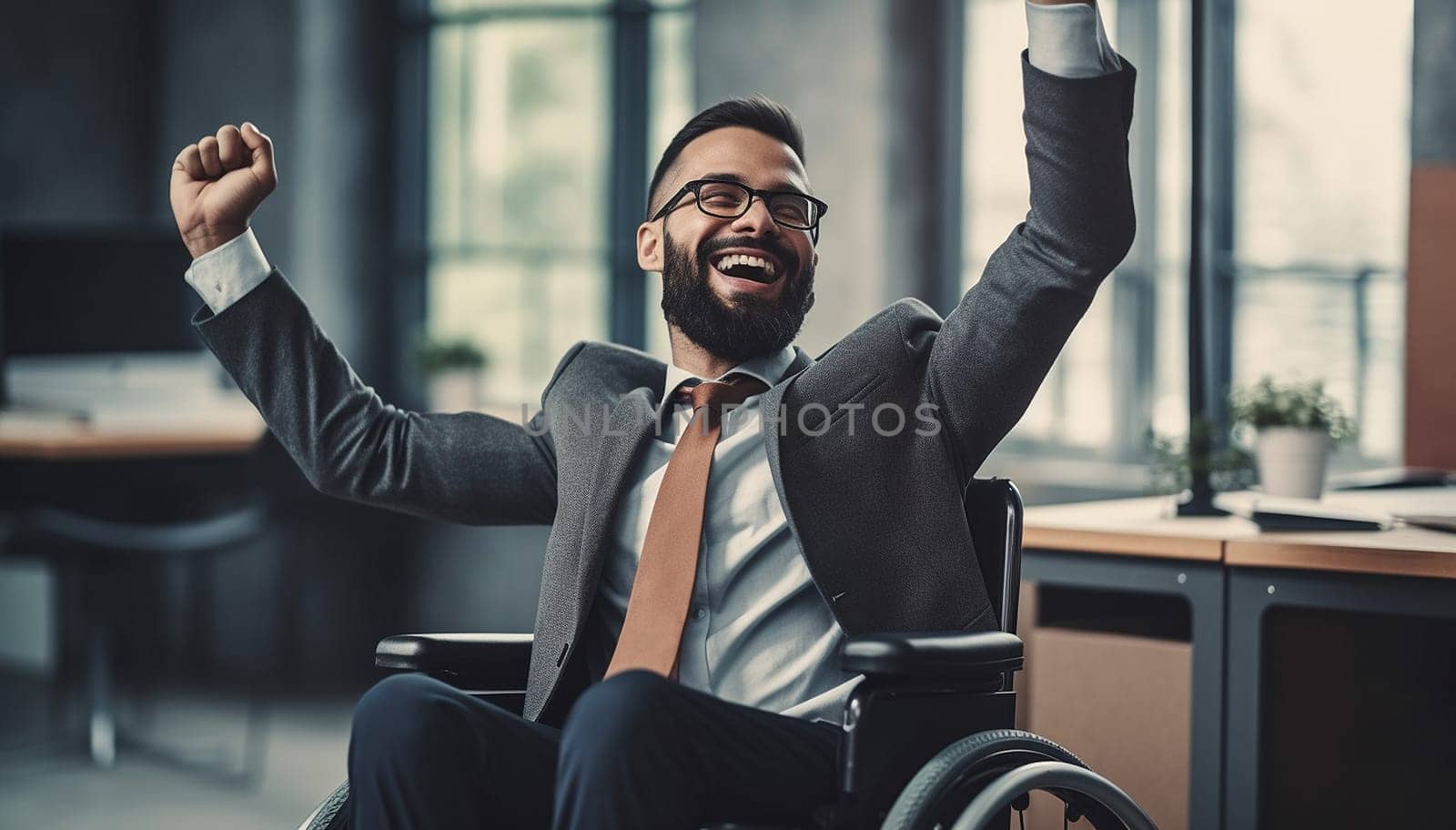 Portrait Of Young Happy successful Disabled business Man in Wheelchair wearing a business suit at the office. Cheering for victory and success modern