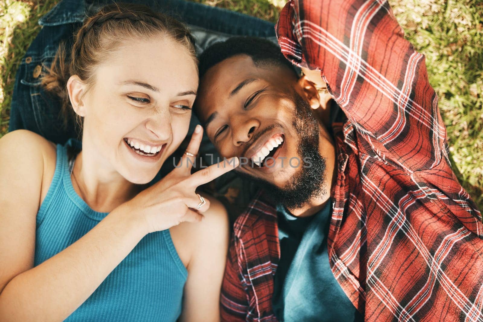 Interracial couple, park selfie and peace on grass with love, happiness and relax on holiday. Black man, woman and profile picture on lawn for social network app with romance, funny and comic time.