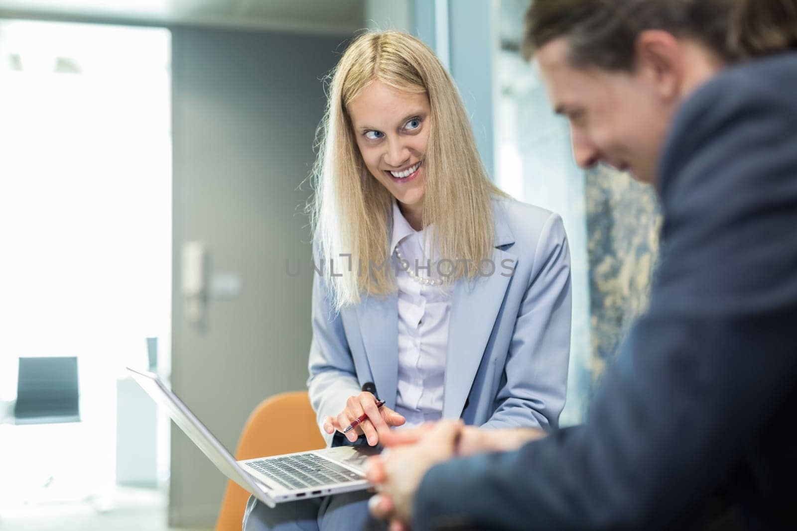 Business meeting. Client consulting. Confident business woman, real estate agent, financial advisor explaining details of project or financial product to client in office