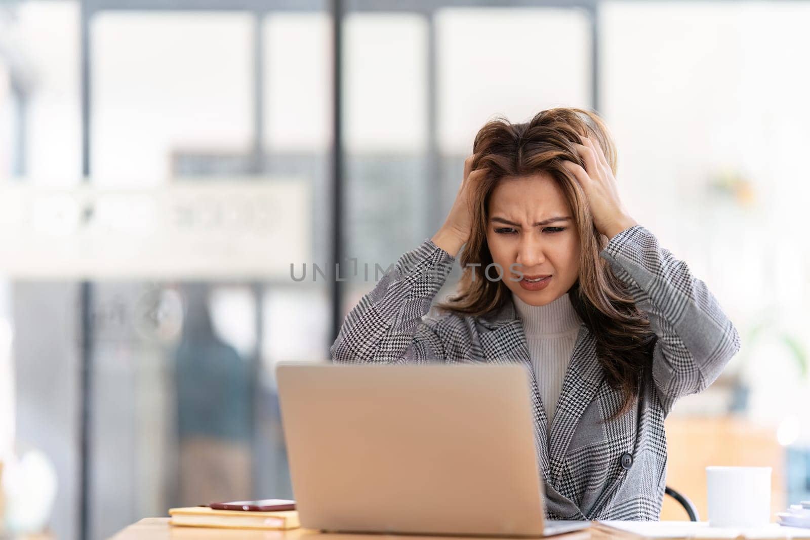 Woman working at with headache, burnout and stress over social media marketing or company deadline. Anxiety, exhausted and tired web or online business advertising expert with migraine.