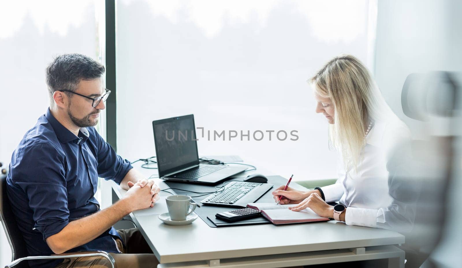 Business meeting. Client consulting. Confident business woman, real estate agent, financial advisor explaining details of project or financial product to client in office. by kasto