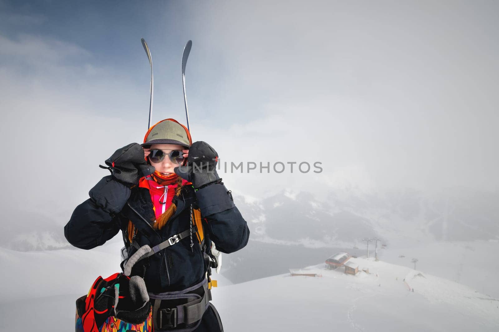 Young woman on a ski vacation in the mountains, portrait. Great rider holiday in ski resort.