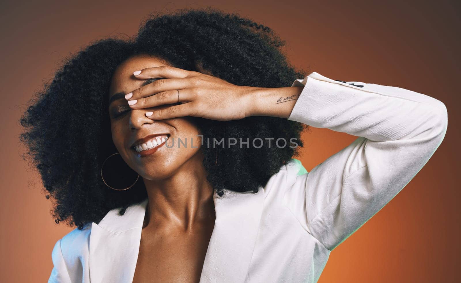 Black woman, hand with manicure and face with beauty, hair care and happy with afro against studio background. Makeup cosmetic, nails and skincare with facial and natural curly hair texture.