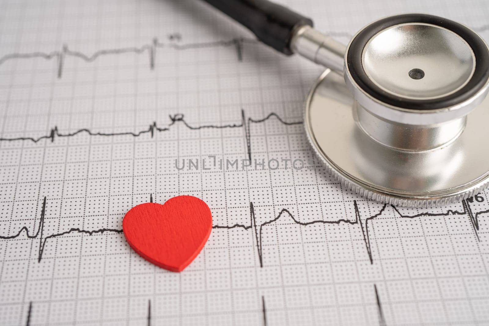 Stethoscope on electrocardiogram ECG with red heart, heart wave, heart attack, cardiogram report.