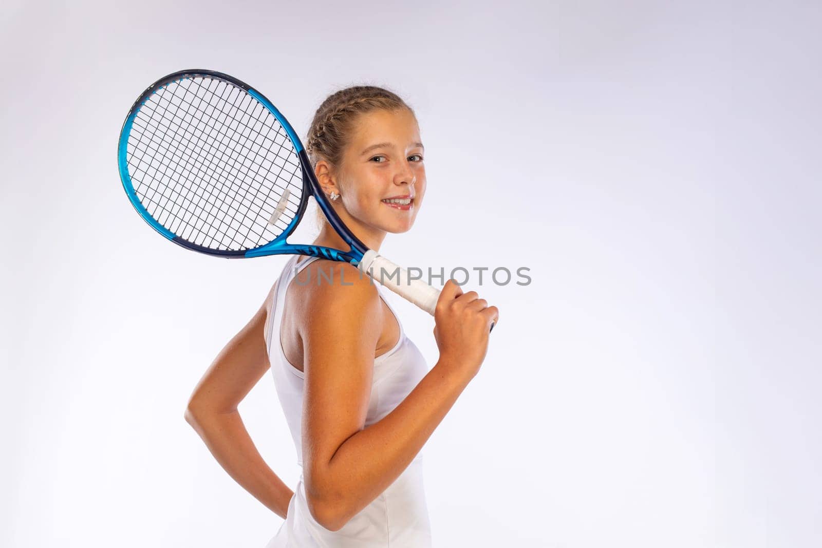Tennis player. Download a photo to advertise your sports tennis academy for kids. Girl athlete teenager with racket isolated on white background. Sport concept