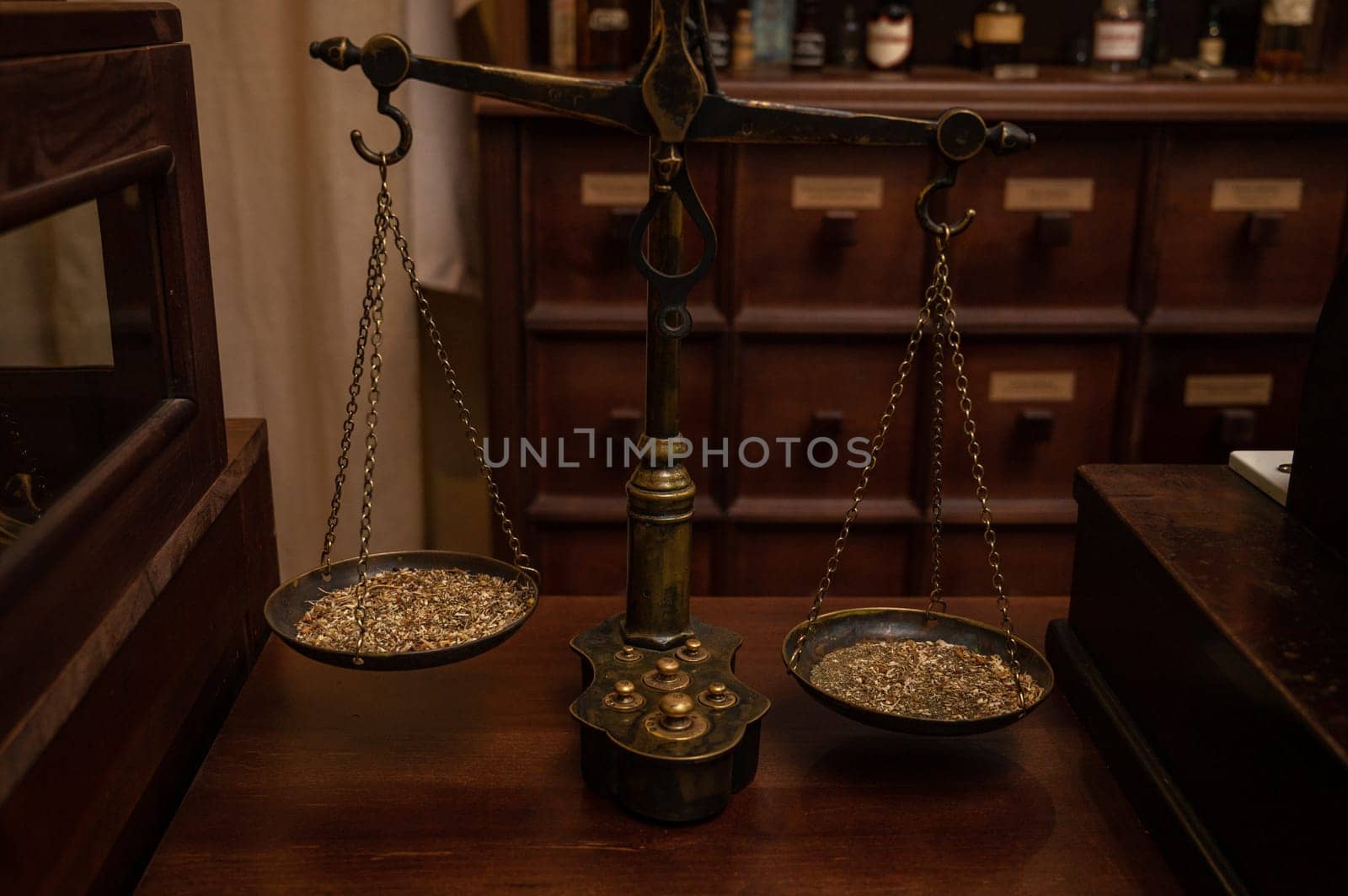 Old classic weight scale on the table of retro pharmacy from the 19th century.