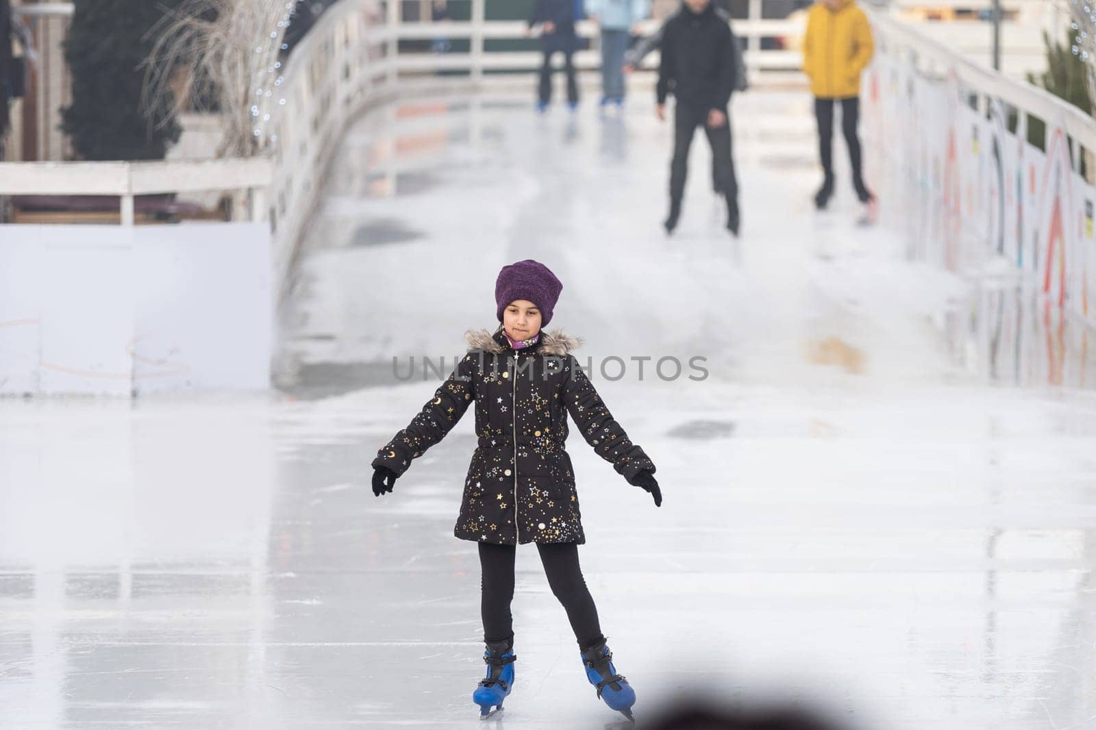teenage girl skating outdoor, ice rink.
