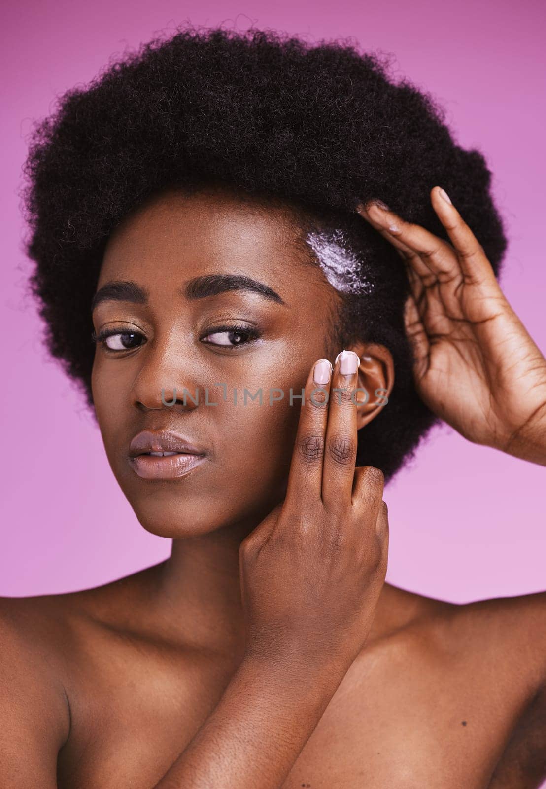 Black woman, hair and cream conditioner for afro, haircare and ethnic texture on pink studio background. African model, hairstyle lotion product and scalp relaxer for maintenance, skincare and beauty.