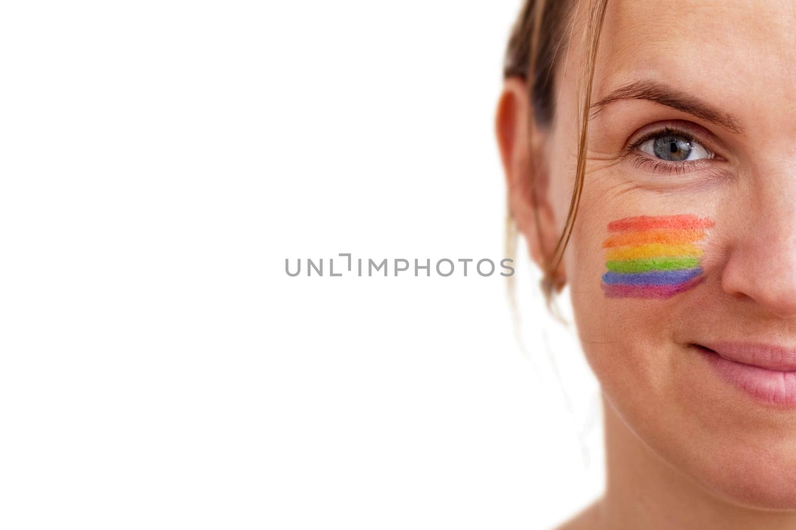 Portrait of a young smiling woman with LGBT flag painted on her cheek by andreyz