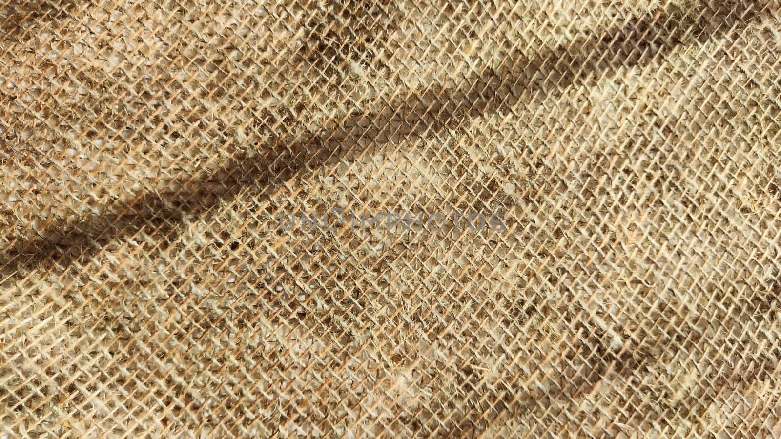 Natural fabric texture, frame and background of burlap. Rough crumpled burlap background. Selective focus