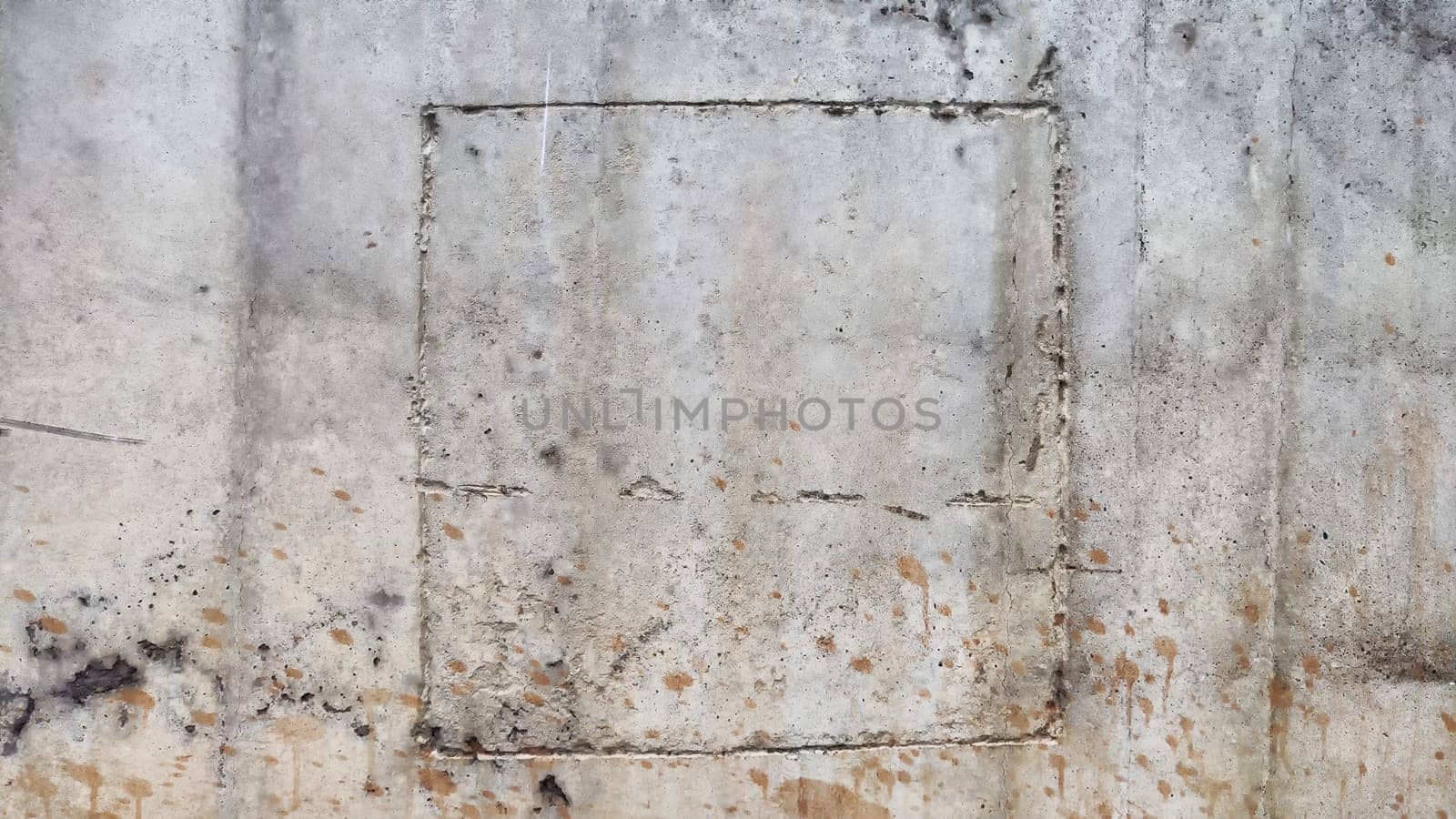 Abstract concrete gray background with dark uneven spots, a square lines as frame and rough texture. Frame and pattern. Copy space