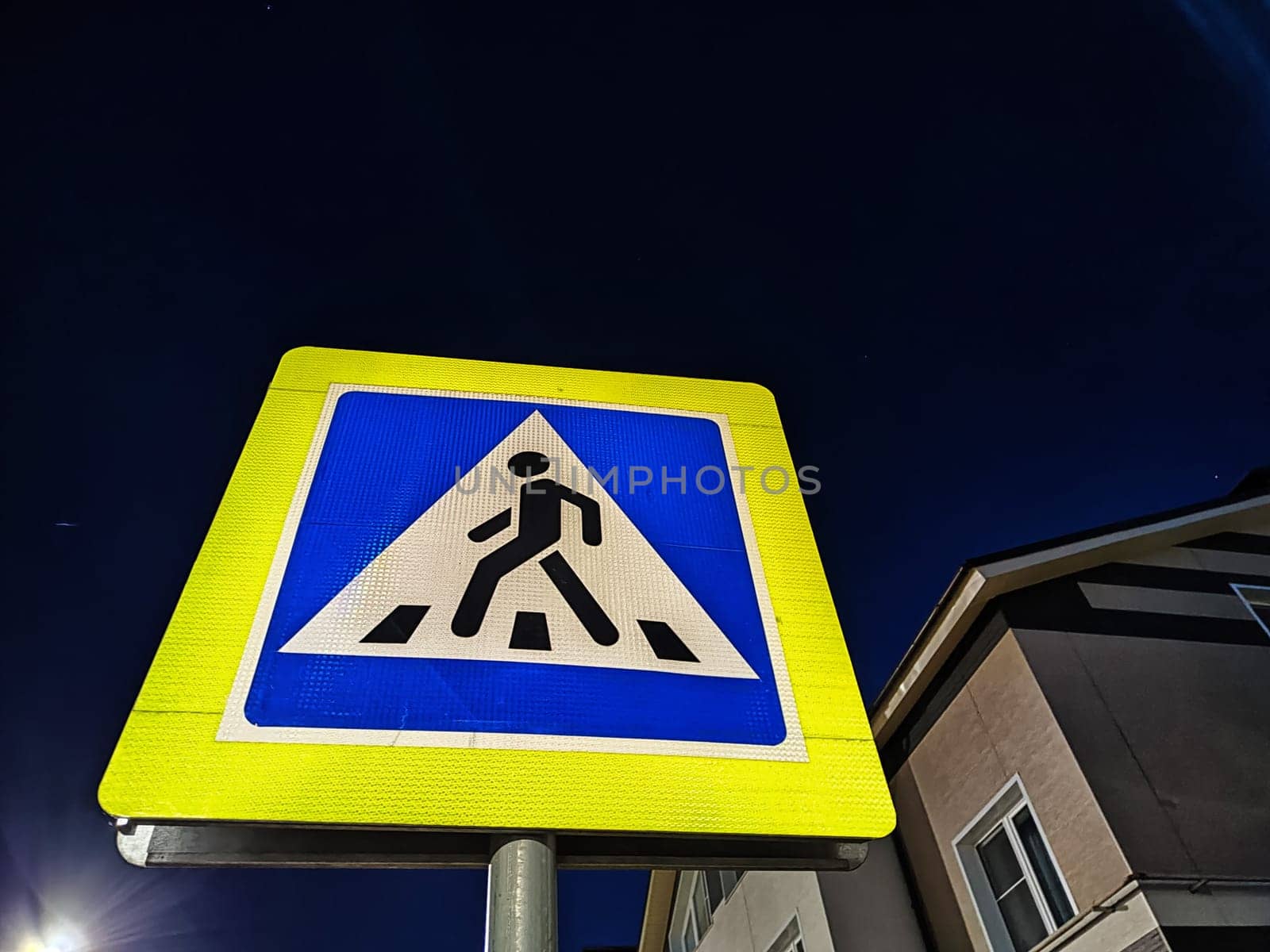 road sign pedestrian crossing on a dark time. City street and road