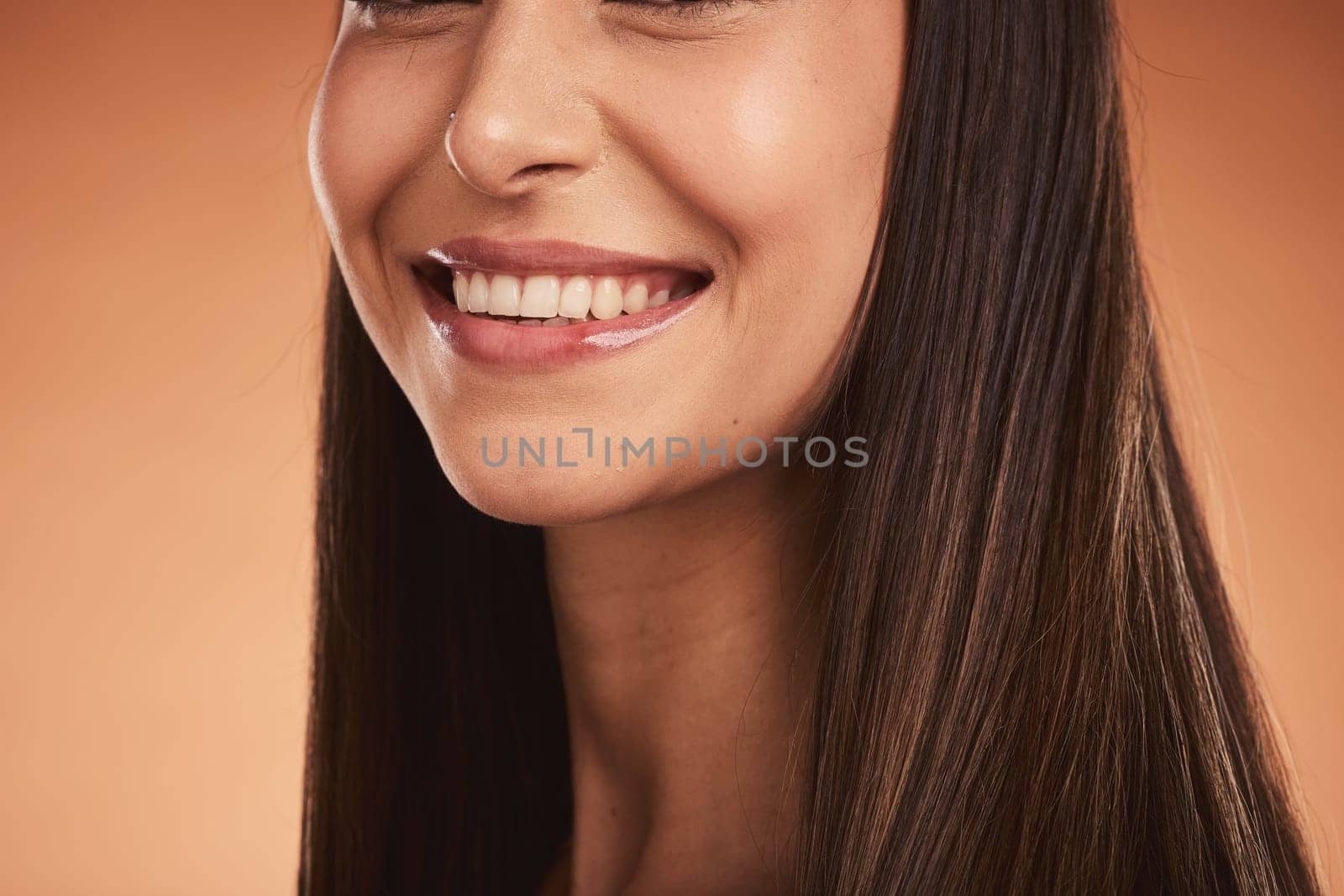 Beauty, smile and teeth, portrait of woman in studio with luxury makeup and dental care for healthy and clean mouth. Health, wellness and beautiful happy model girl with big smile on brown background by YuriArcurs