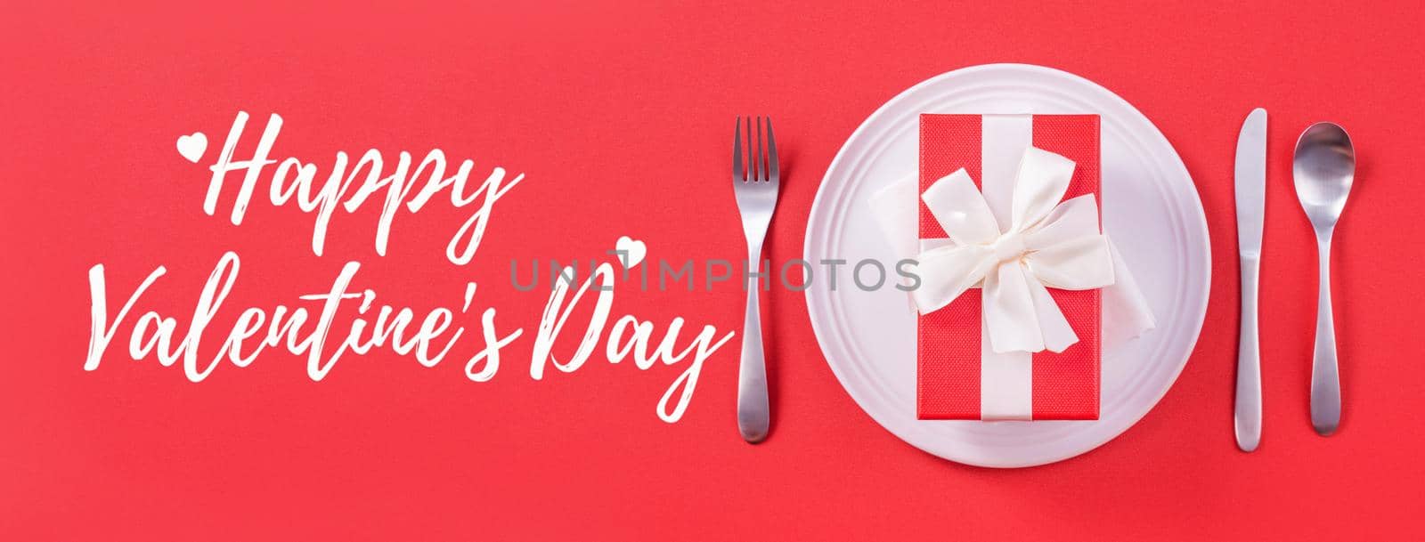 Valentine's Day holiday dating meal, banquet greeting card design concept - White plate with cutlery on red background, top view, flat lay. by ROMIXIMAGE