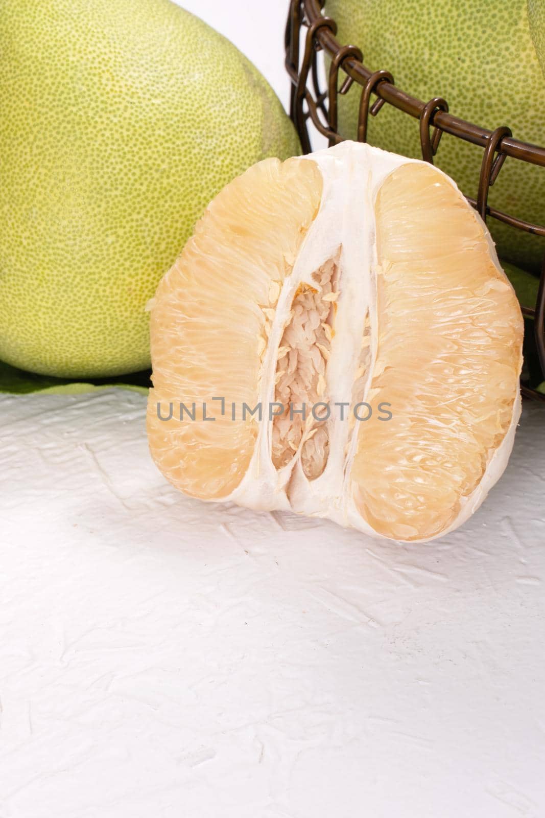 Fresh peeled pomelo, pummelo, grapefruit, shaddock on bright wooden table background. Seasonal fruit for Mid-Autumn Festival, close up, copy space. by ROMIXIMAGE