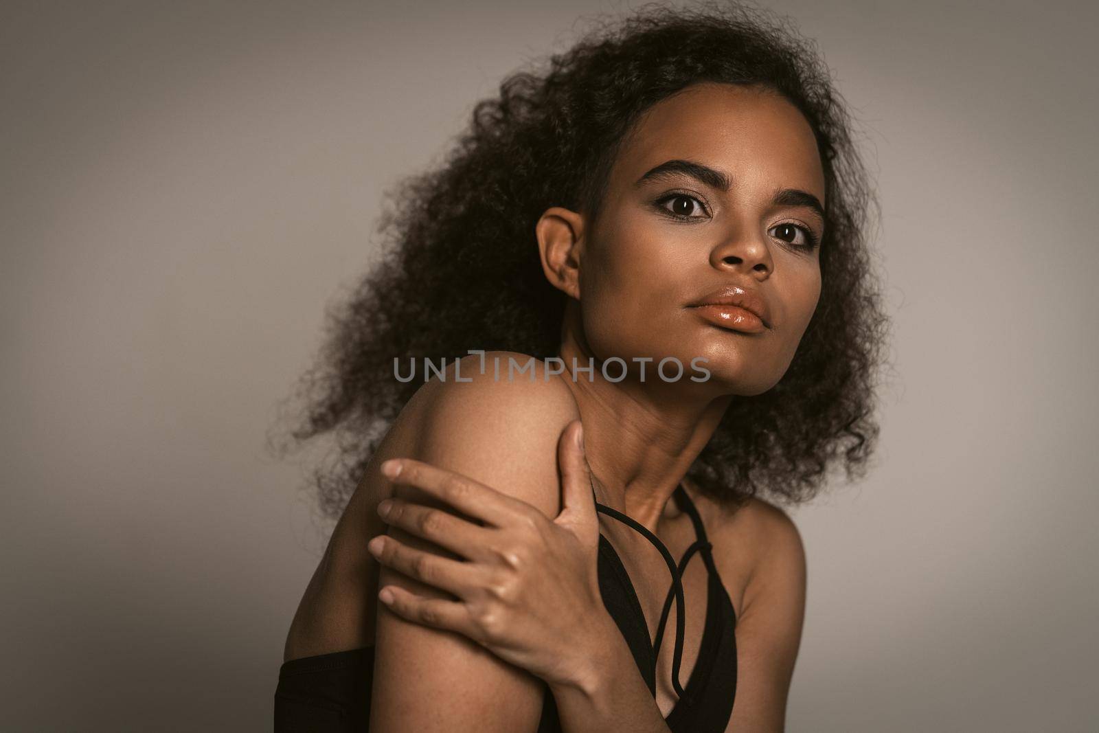 Scared young girl covering herself with her hands. Stop violence against Women. Women violence and abused concept. trafficking Concept by LipikStockMedia