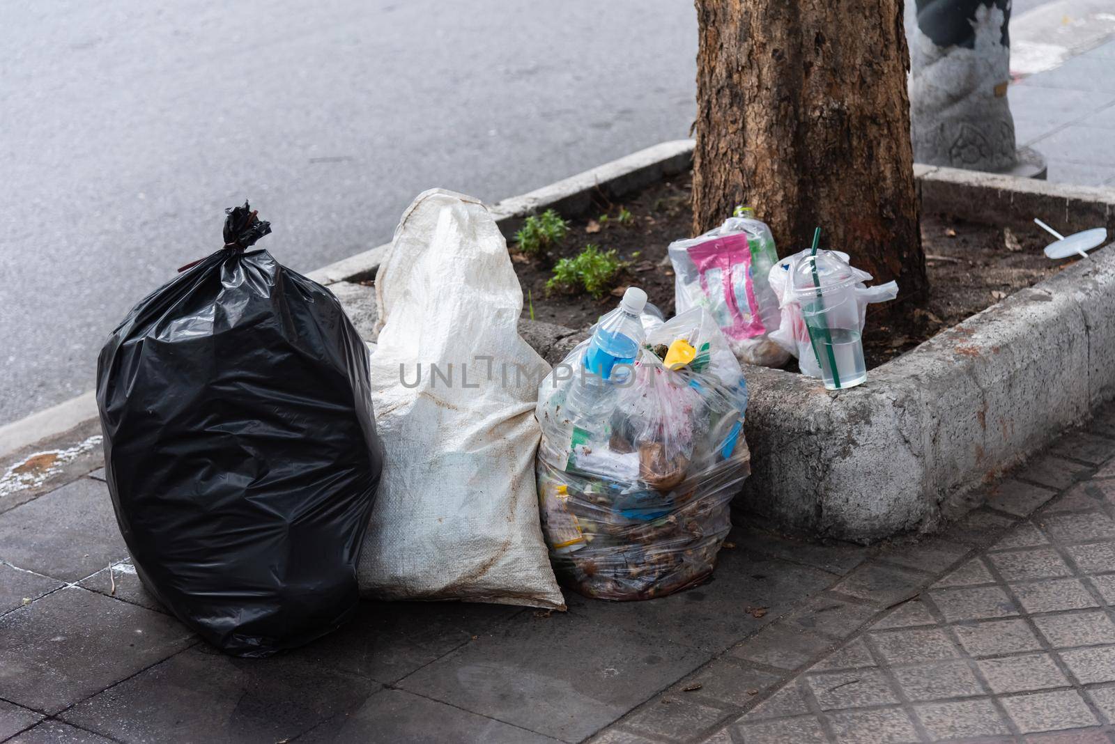 garbage on the sidewalk, recycle concept by Wmpix