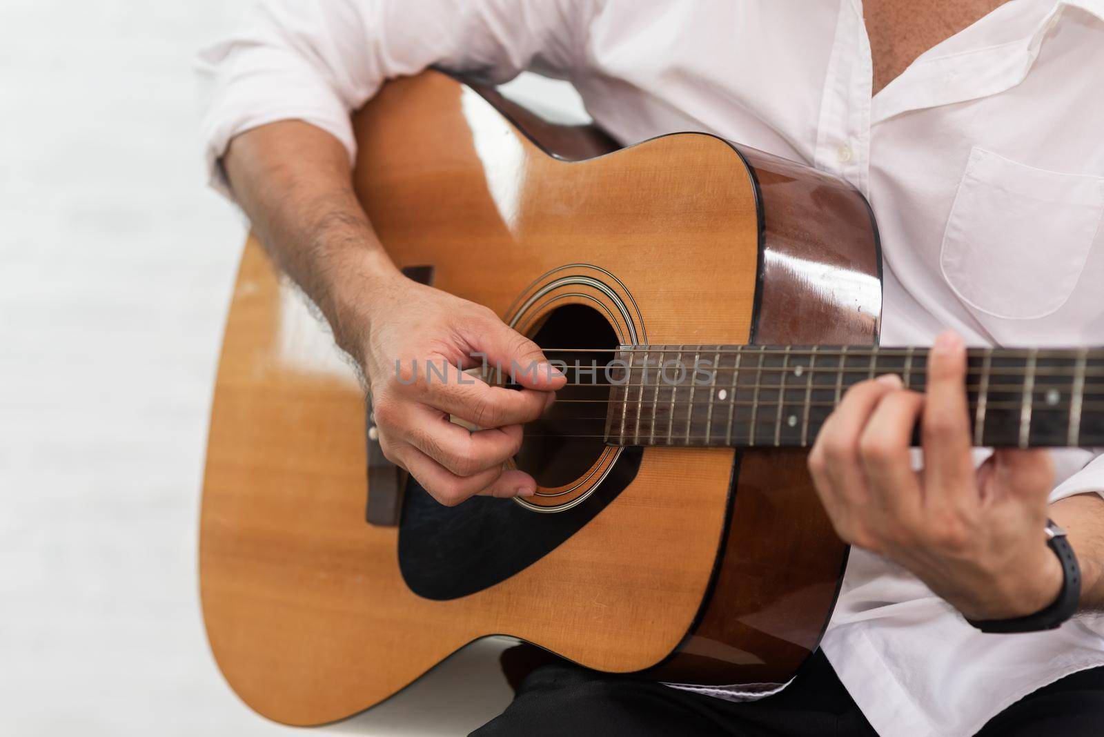 man playing guitar on white background