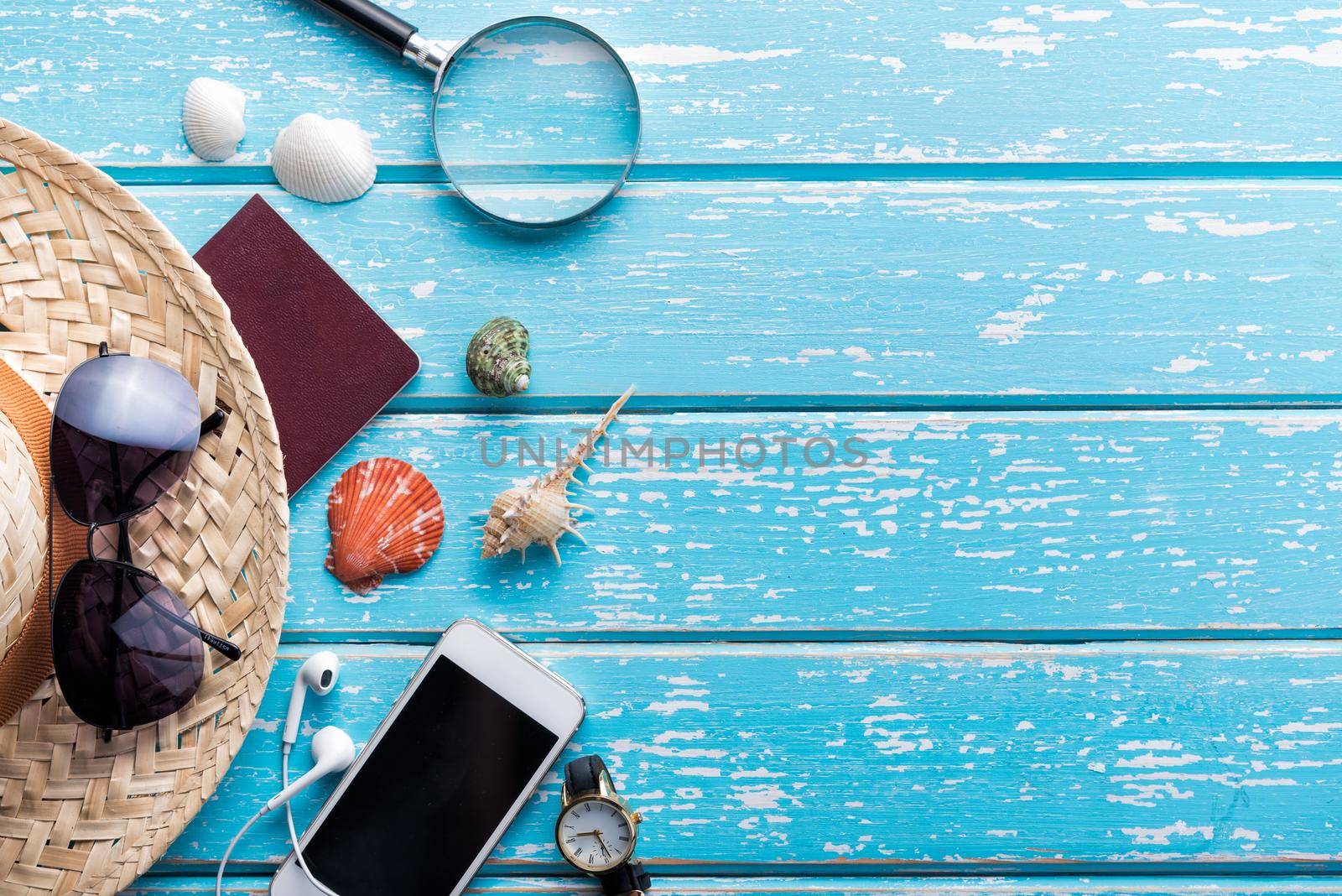 Top view of Traveler's accessories, Flat lay photography of Travel concept on blue background by Wmpix