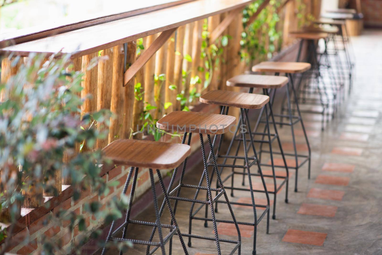 wood chairs and wood table in the cafe by Wmpix