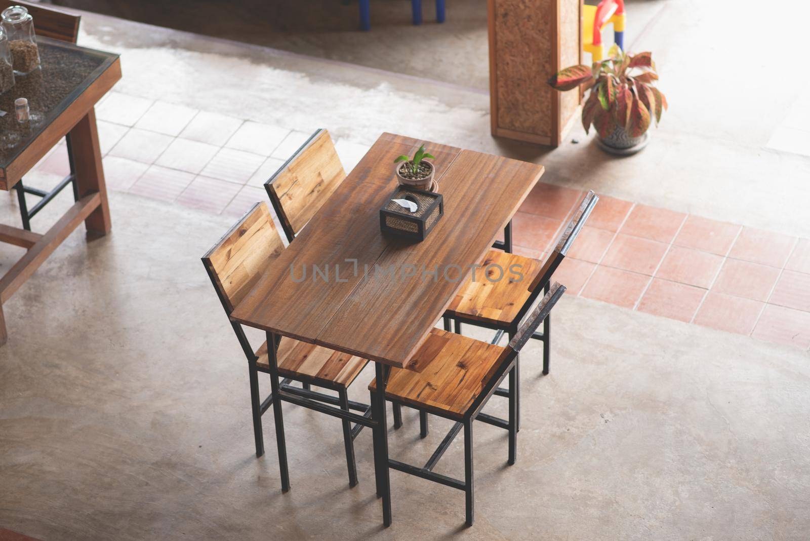 wood chairs and wood table in the cafe by Wmpix