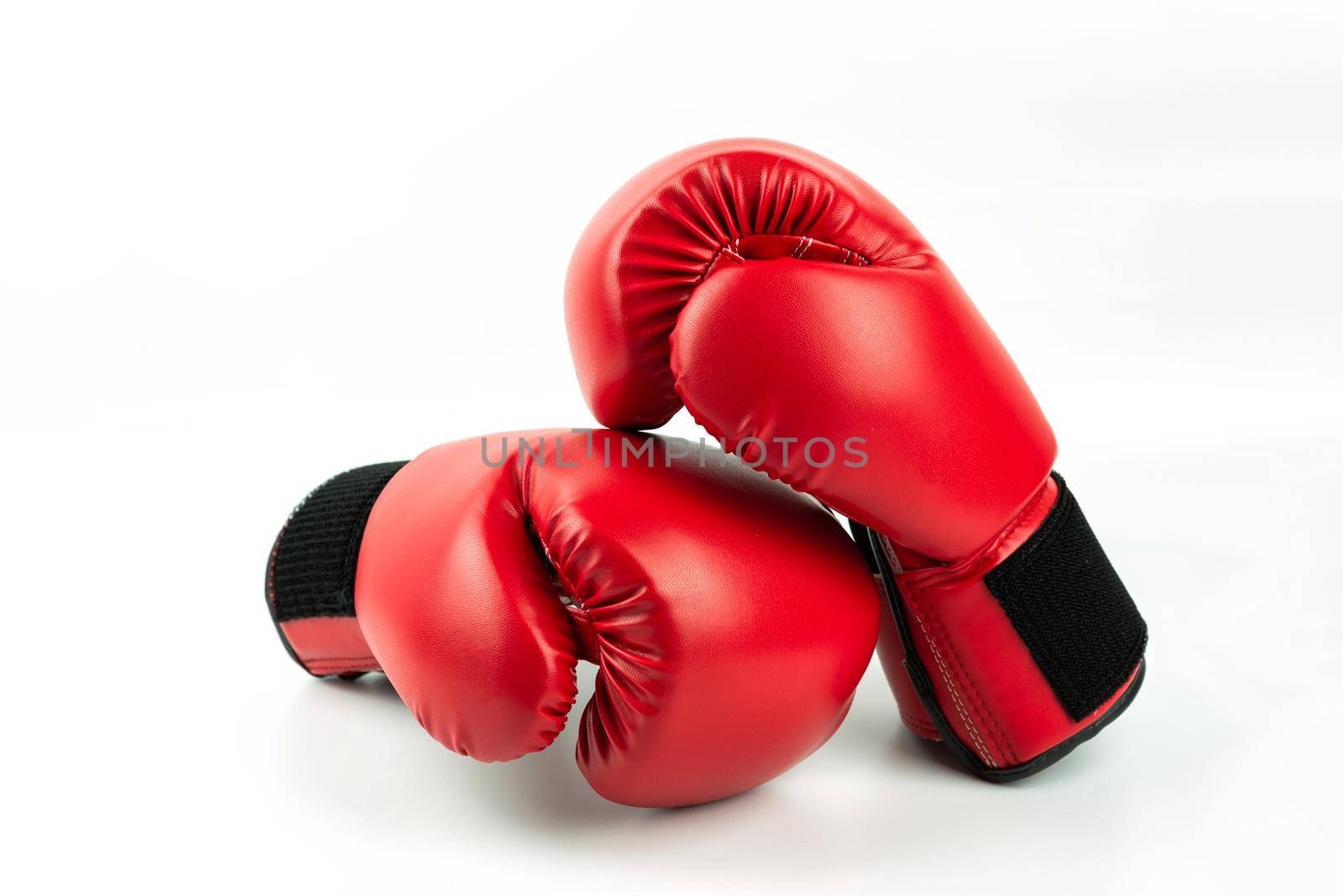 Red leather boxing gloves isolated on white background by Wmpix