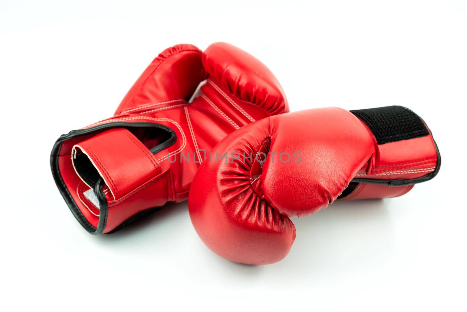 Red leather boxing gloves isolated on white background by Wmpix