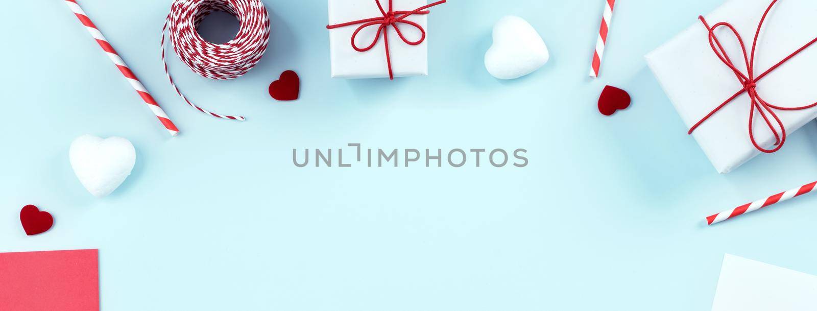 Valentine's Day, Mother's day art design concept for promotion - Red, white wrapped gift box isolated on pastel light blue color background, flat lay, top view. by ROMIXIMAGE