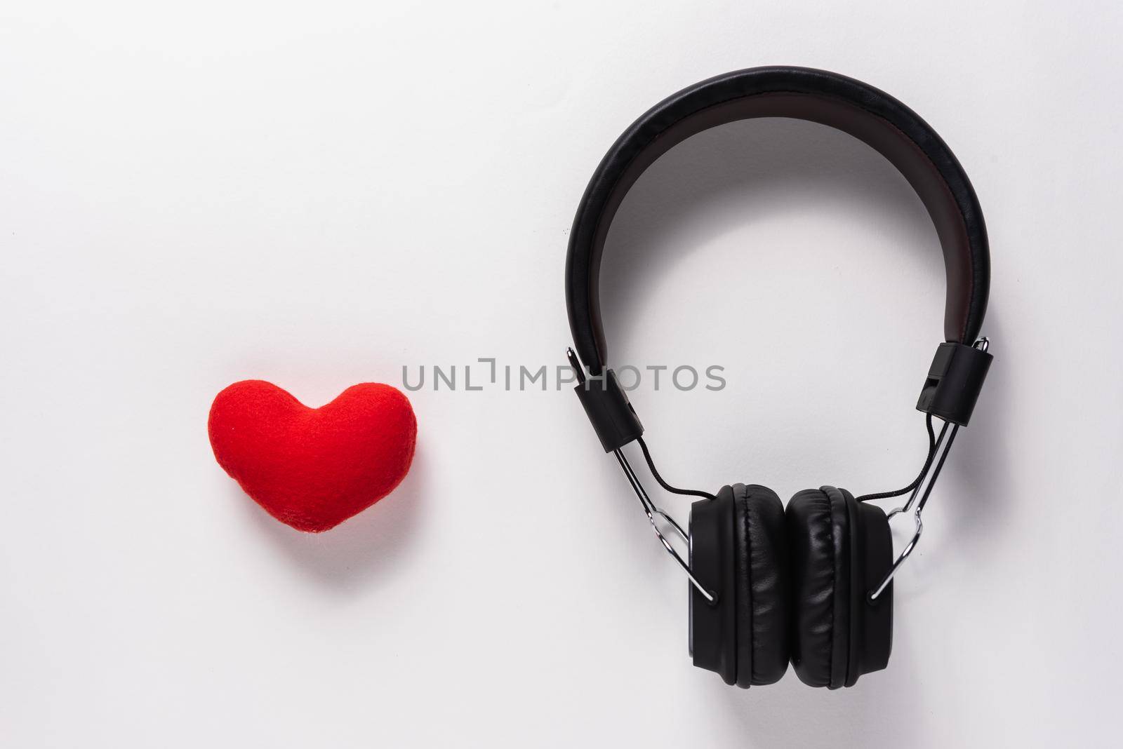 flat lay of earphone and mobile phone on white background, music concept