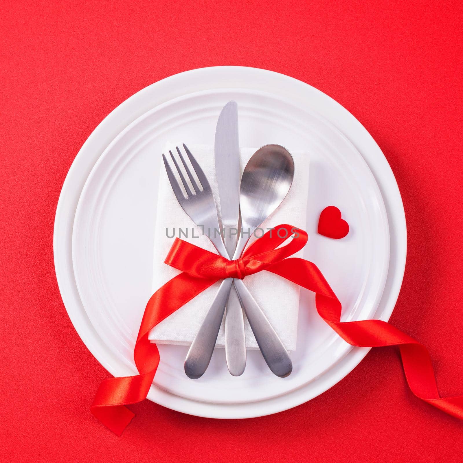 Valentine's Day meal design concept - Romantic plate dish set isolated on red background for restaurant, holiday celebration promotion, top view, flat lay.
