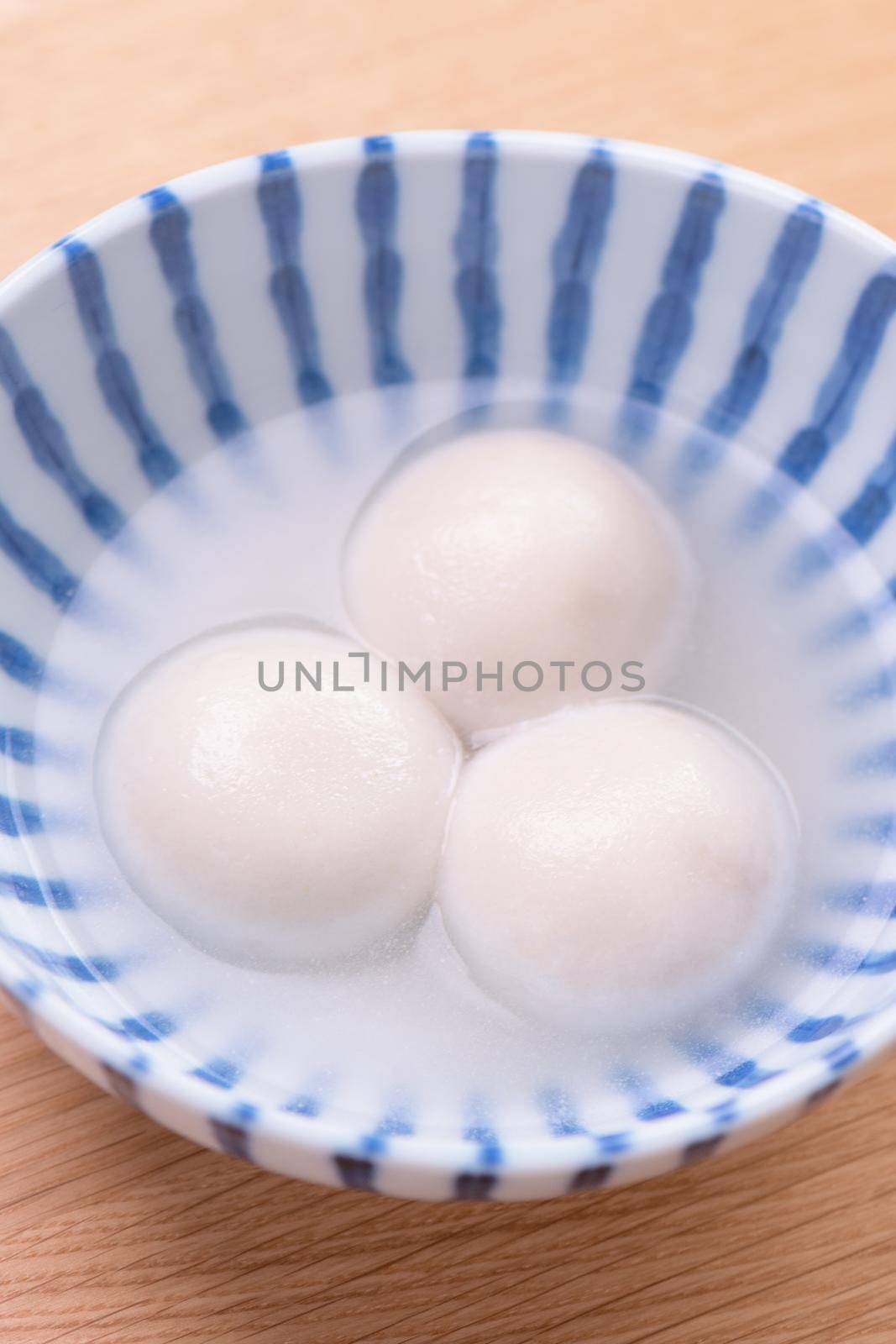 Tang yuan, tangyuan, yuanxiao in a small bowl. Delicious asian traditional festive food rice dumpling balls with stuffed fillings for Chinese Lantern Festival, close up. by ROMIXIMAGE