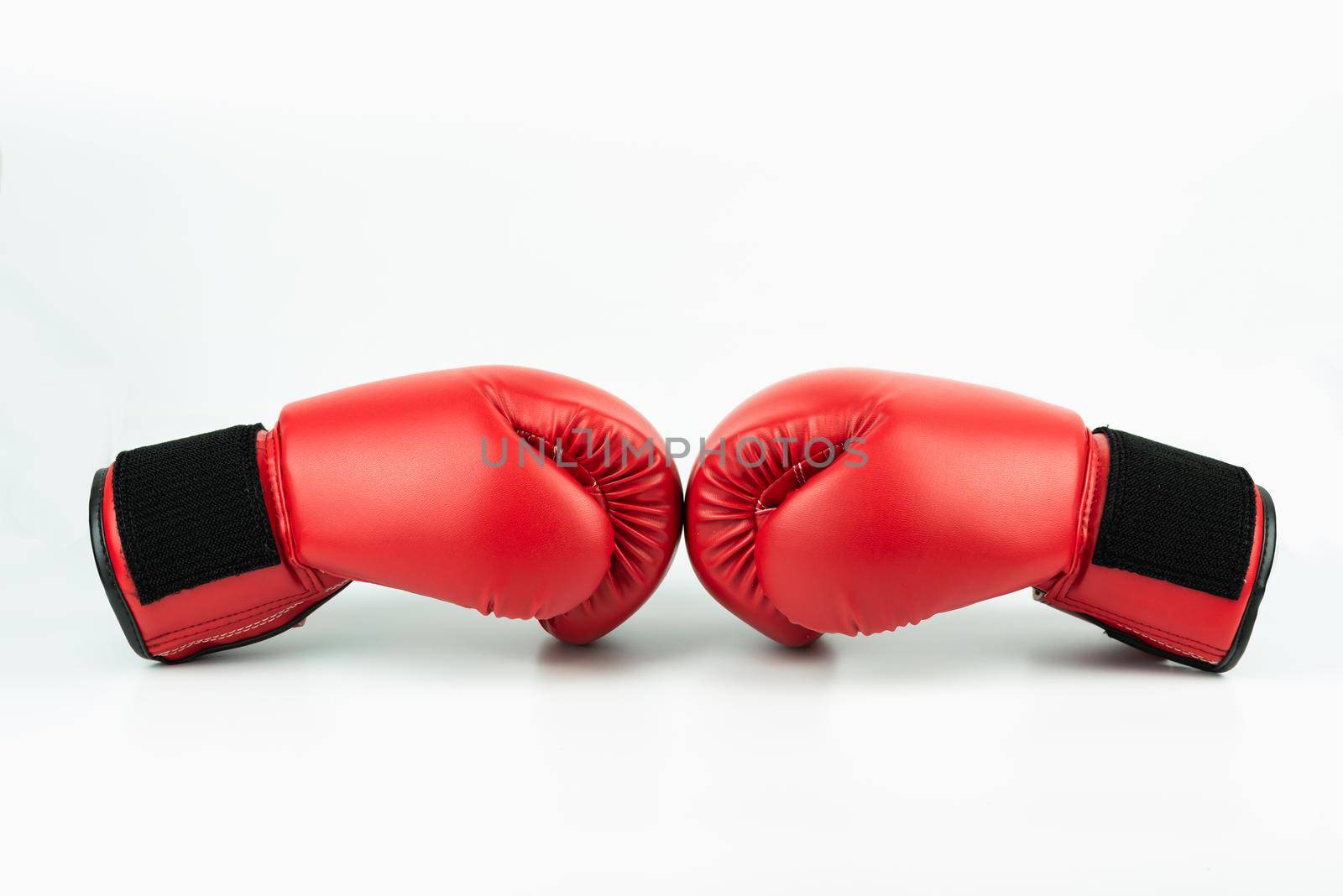 Red leather boxing gloves isolated on white background by Wmpix