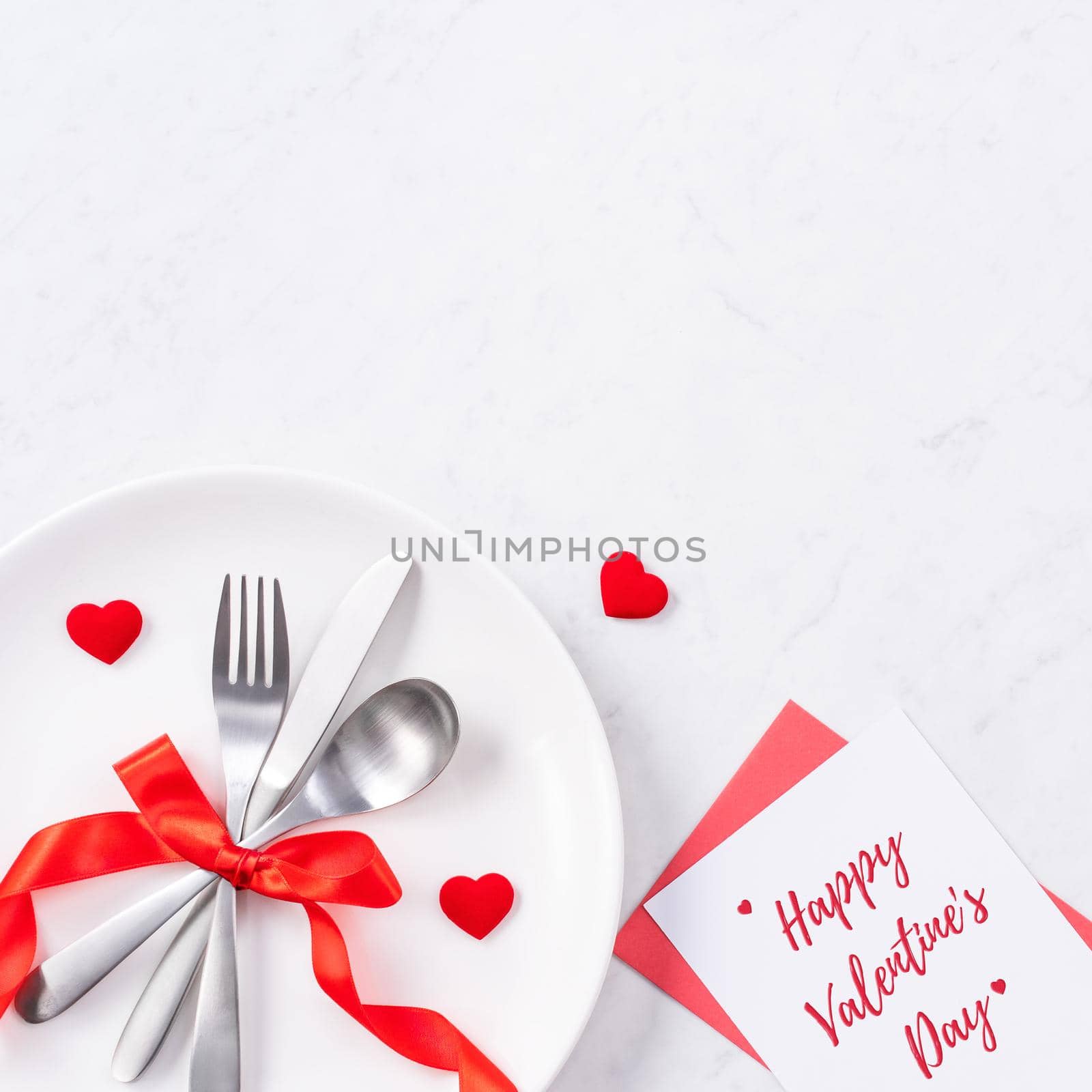 Valentine's Day holiday dating meal, banquet greeting card design concept - White plate and red ribbon on marble background, top view, flat lay. by ROMIXIMAGE