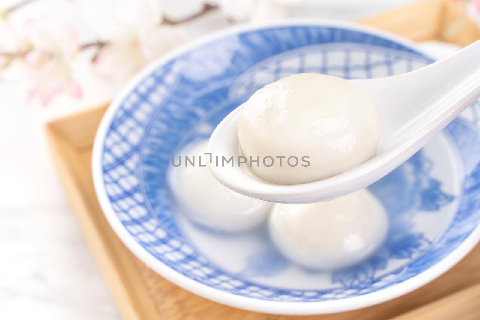 Delicious tang yuan, yuanxiao in a small bowl. Asian traditional festive food rice dumplings ball with stuffed fillings for Chinese Lantern Festival, close up.