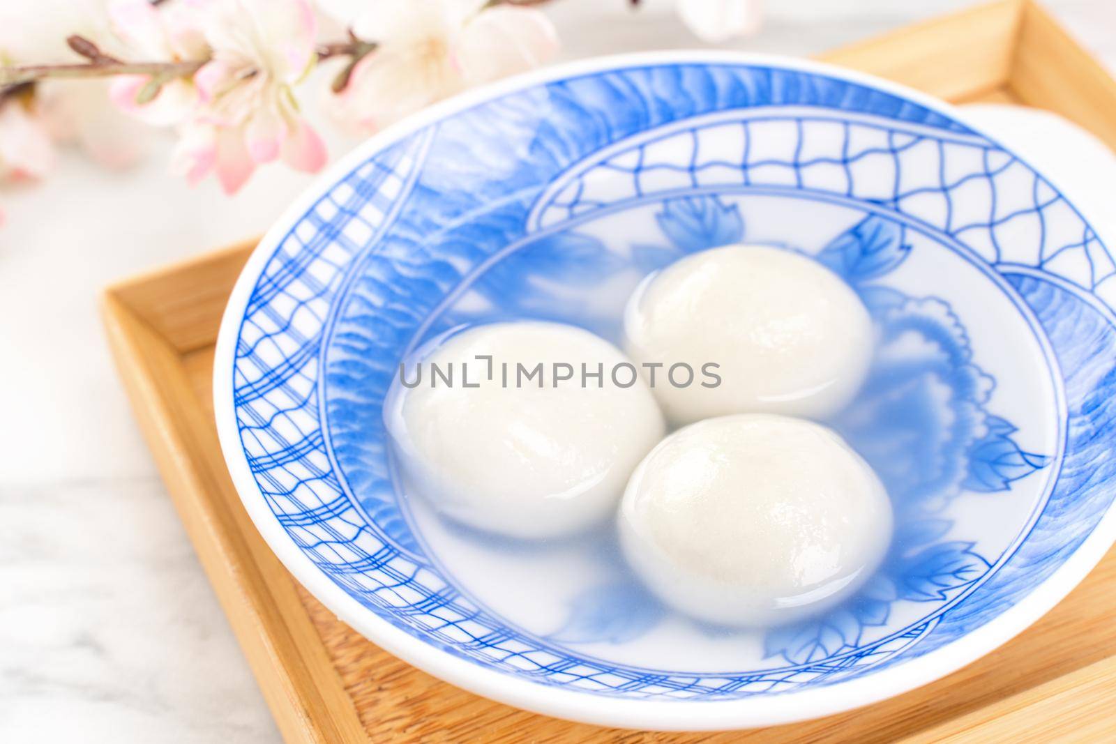 Delicious tang yuan, yuanxiao in a small bowl. Asian traditional festive food rice dumplings ball with stuffed fillings for Chinese Lantern Festival, close up. by ROMIXIMAGE