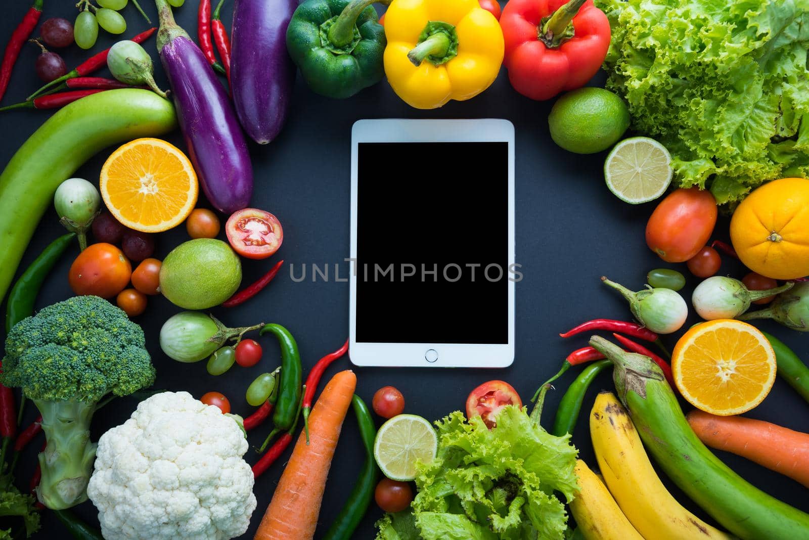 Healthy food concept of fresh organic vegetables and wooden desk background. Ingredients top view