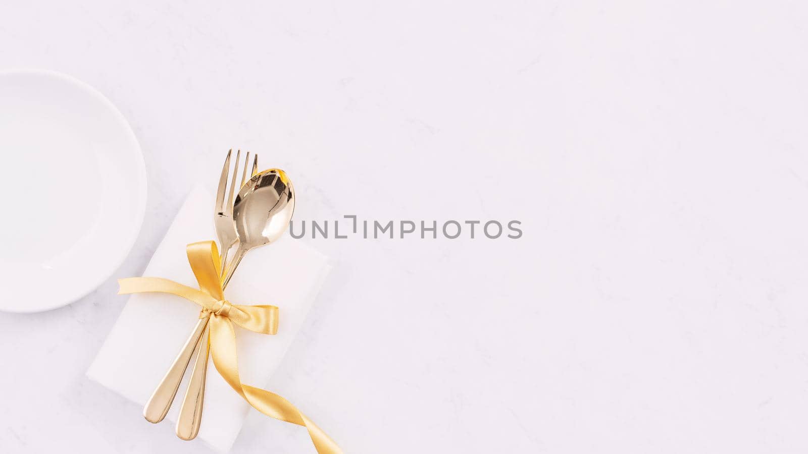 Valentine's Day, Mother's Day, holiday dating meal, banquet design concept - White plate and golden ribbon on marble background, top view, flat lay. by ROMIXIMAGE