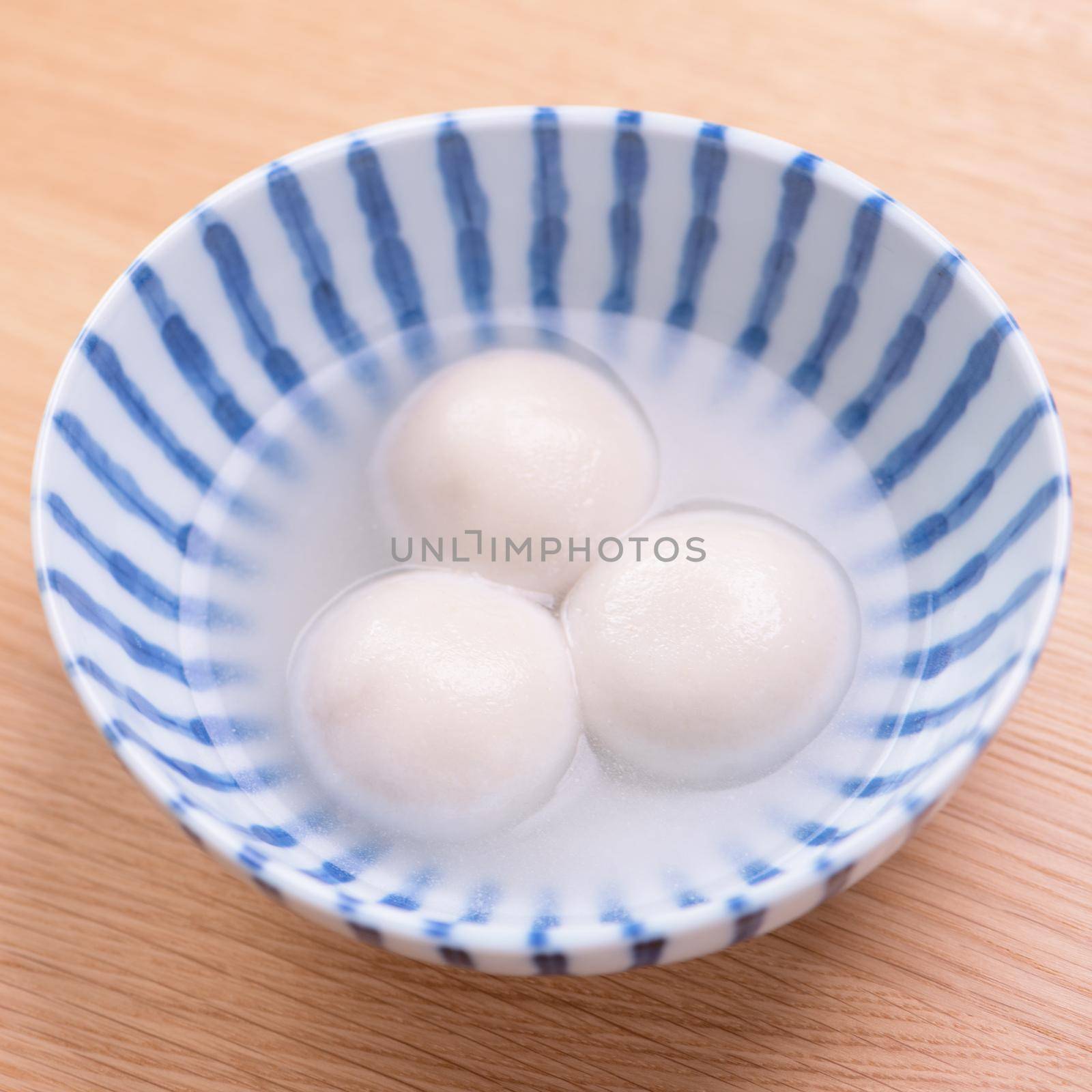 Tang yuan, tangyuan, yuanxiao in a small bowl. Delicious asian traditional festive food rice dumpling balls with stuffed fillings for Chinese Lantern Festival, close up.