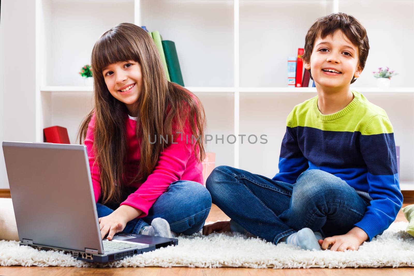 Children using laptop at home.