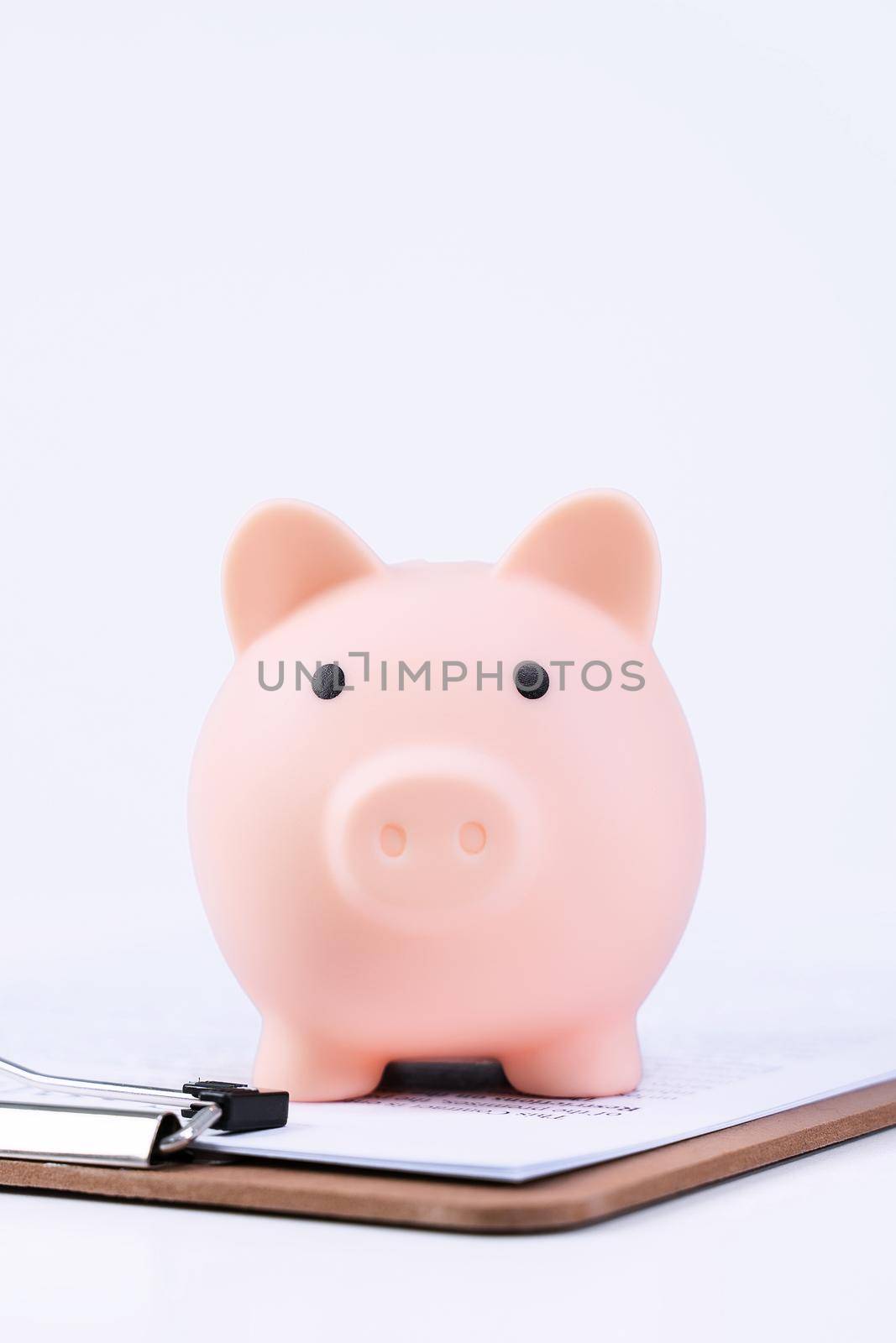 Financial concpet - Piggy bank, beautiful red white wooden house model on white background, saving money to buy insurance, close up, copy space. by ROMIXIMAGE