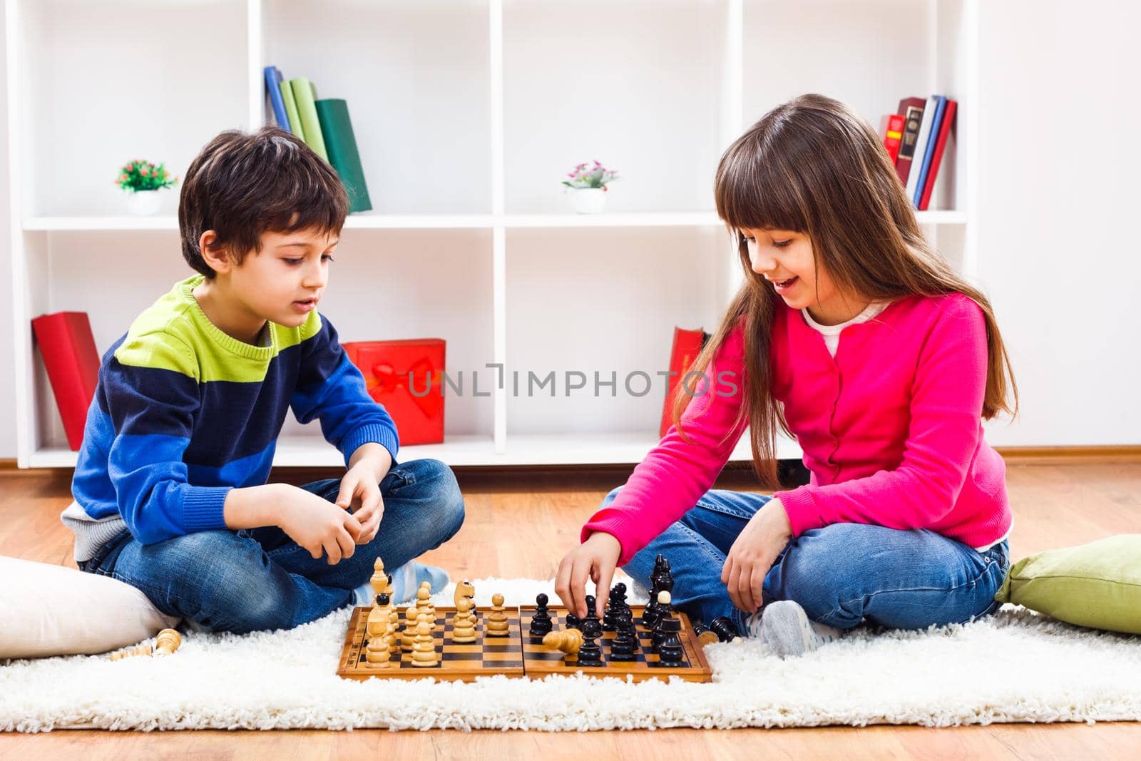Image of children playing chess at home.