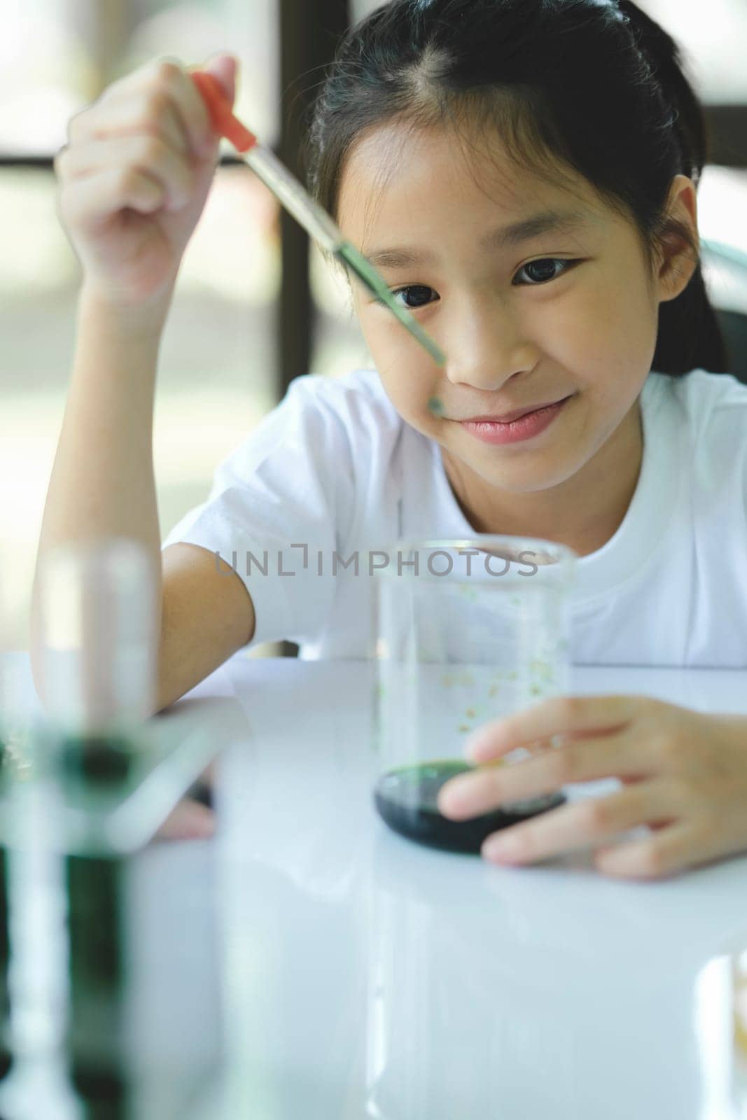 Little child with learning science class in school laboratory by ijeab