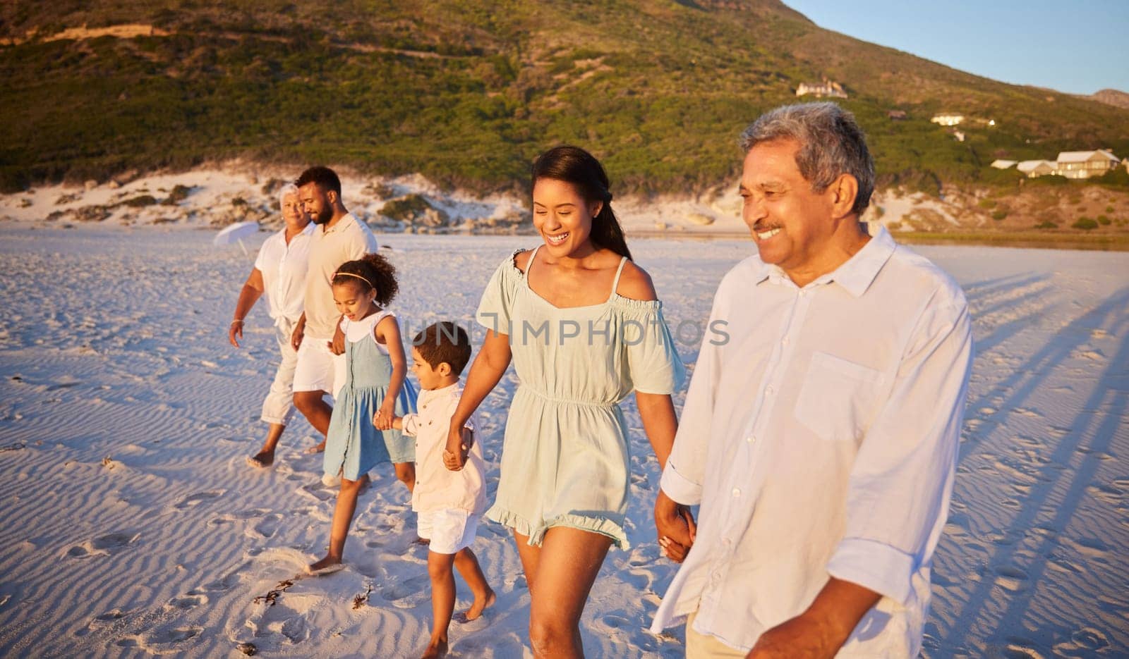 Big family, holding hands or happy kids at sea walking with grandparents on holiday vacation together. Dad, mom or children siblings bonding or smiling with grandmother or grandfather on beach sand.