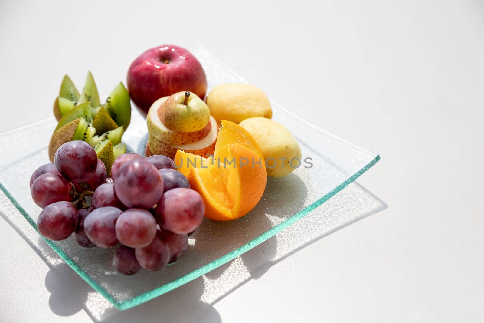 Healthy fruit platter, strawberries raspberries oranges plums apples kiwis grapes blueberries