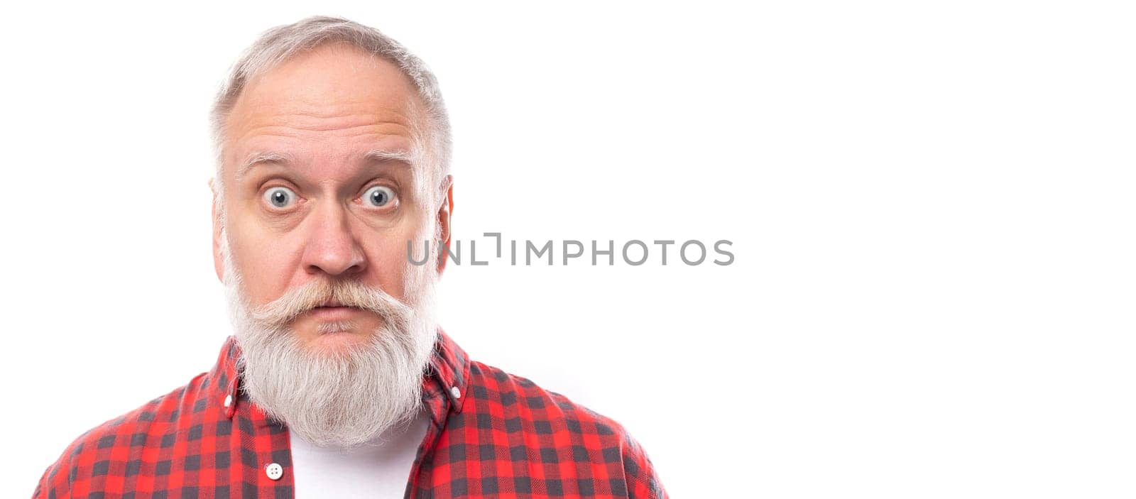 surprised mature gray-haired man with a beard and mustache with wide open eyes on a white background with copy space.