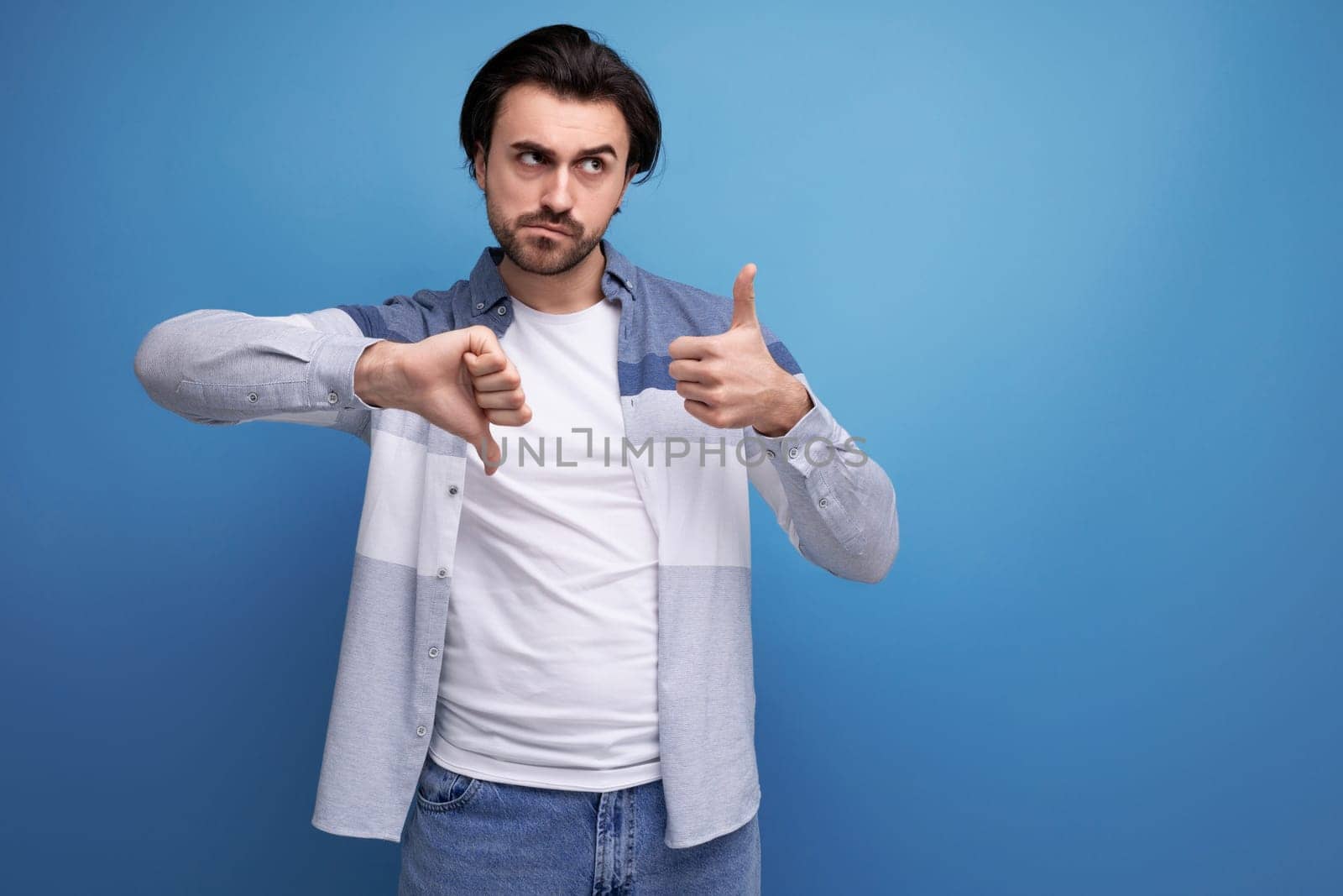 serious brutal brunette man in informal style.