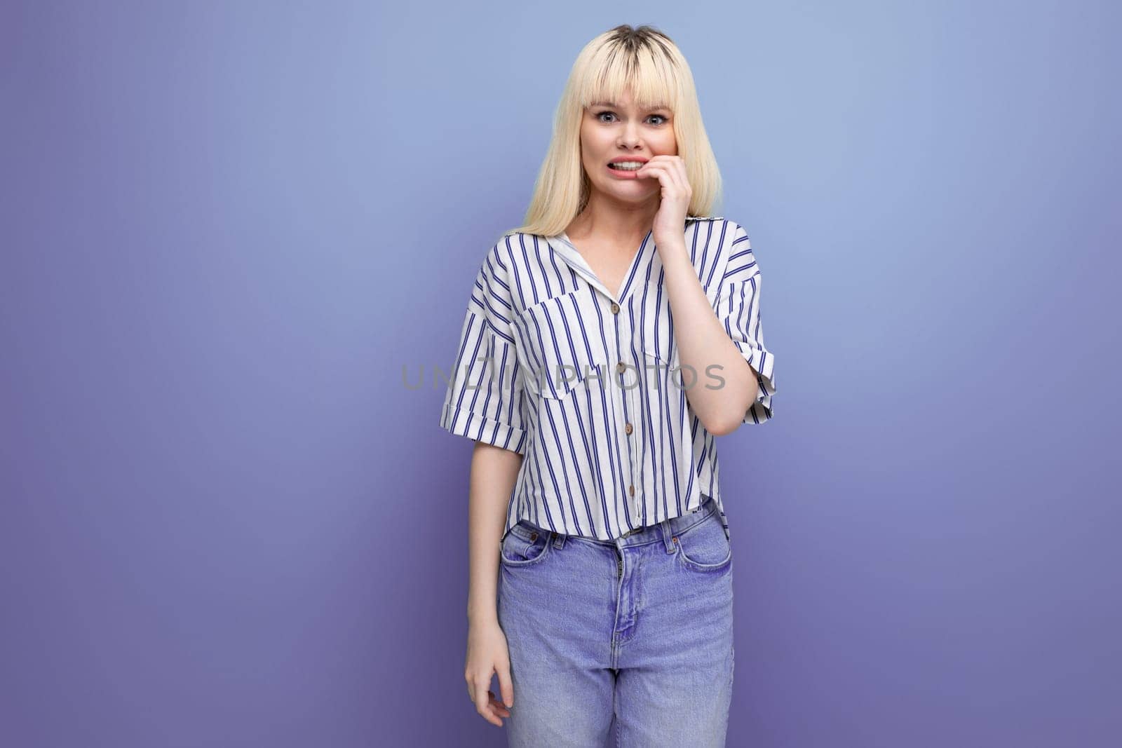 upset stressed blonde young female adult in blouse isolated background.