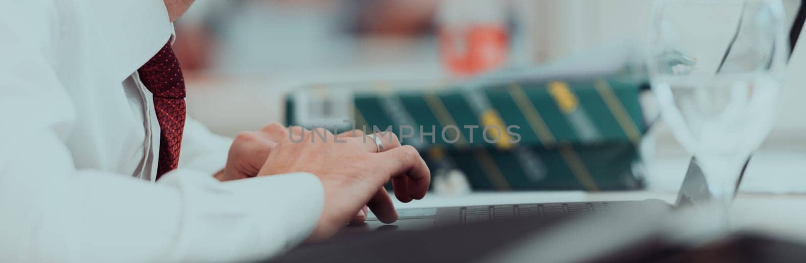 Close up of business hands are typing on laptop.
