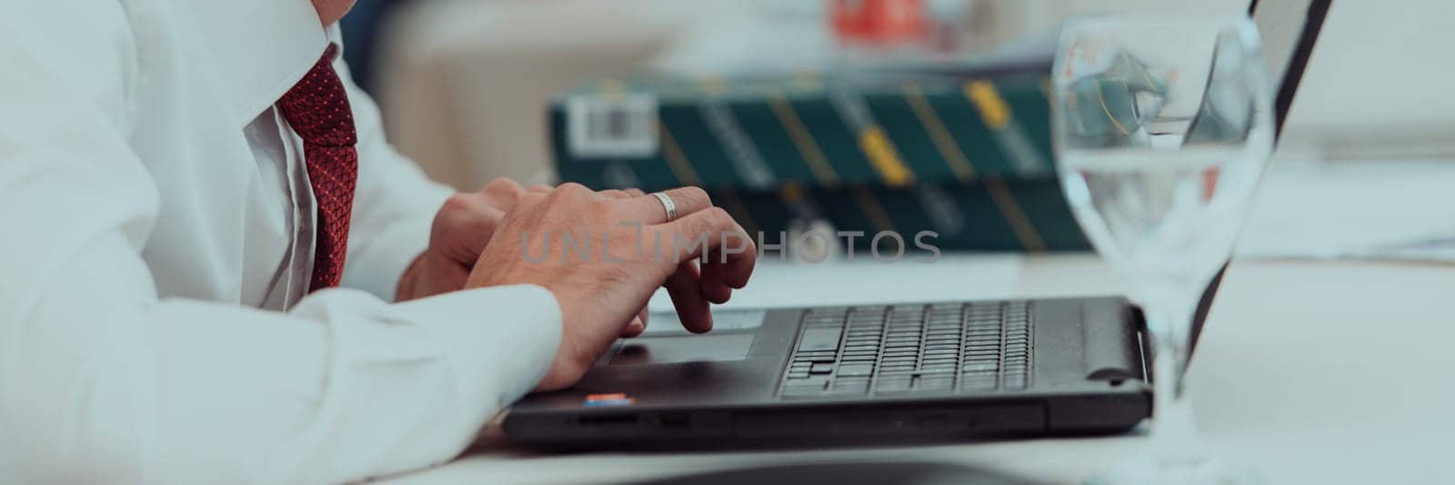 Close up of business hands are typing on laptop.